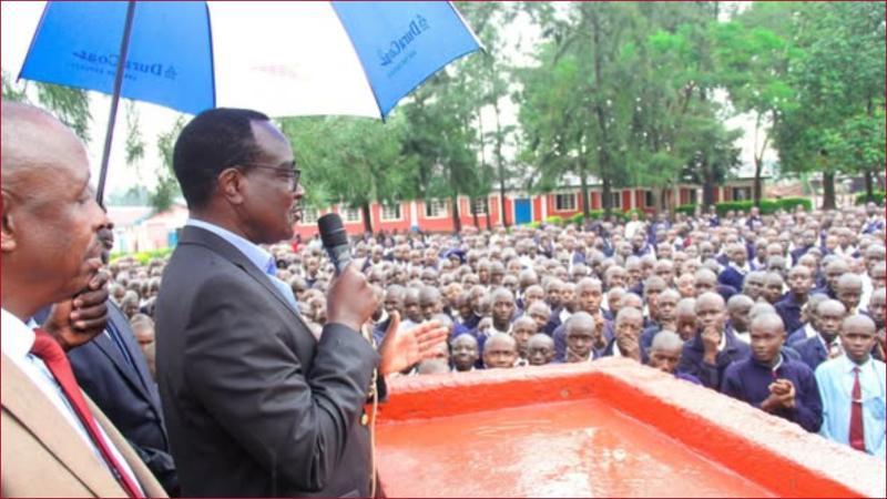 Education CS Julius Ogamba addresses students in a past academic function.